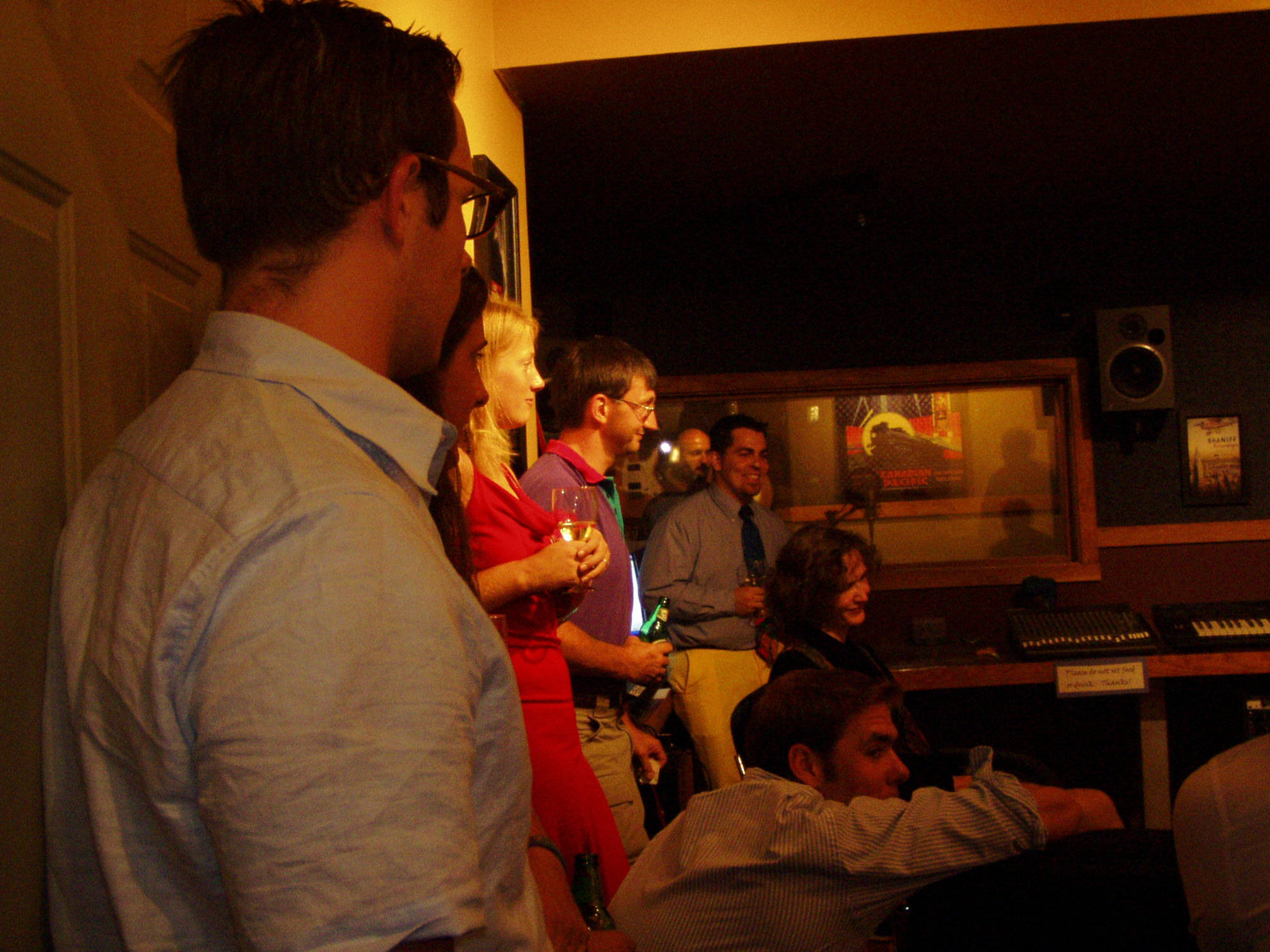 Some of the 40 people crowded into the control room at Night Train Studios Grand Opening